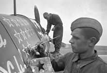 RIAN archive 247 A soldier drawing stars on the plane.jpg